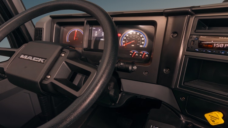 A steering wheel and dashboard of a car Description automatically generated
